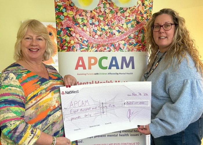 Volunteers with handmade quilts for APCAM
