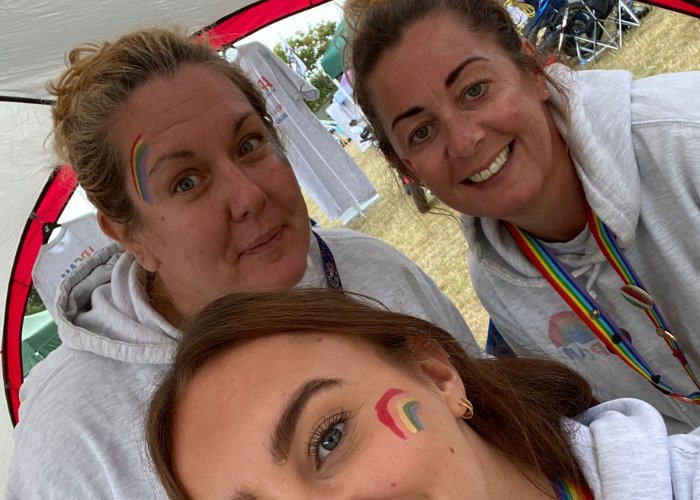 The APCAM team with rainbow face paint at a local festival