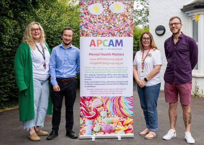 The APCAM team with our Mental Health Matters banner